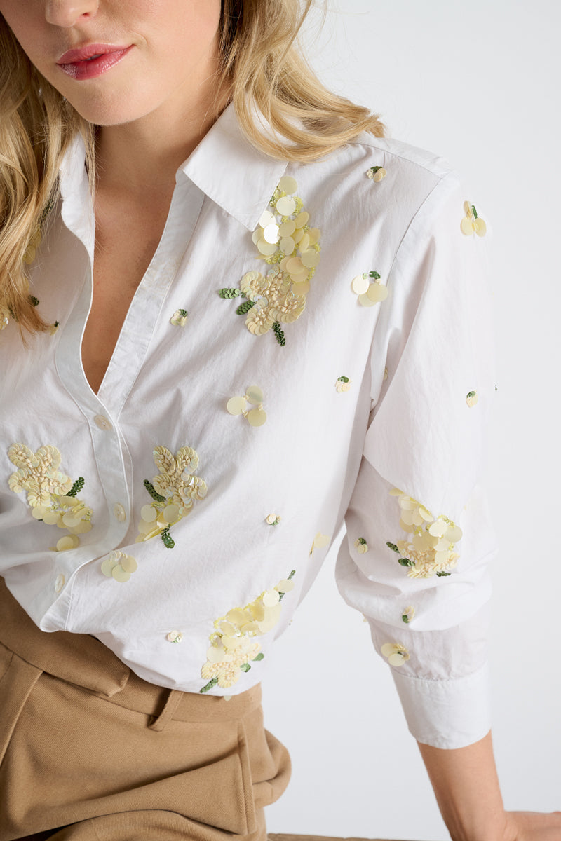 Witte bloes met gele pailletten