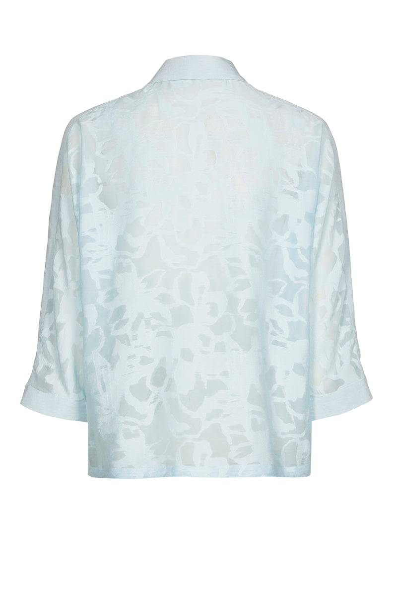 Chemisier-polo bleu clair à fleurs transparentes