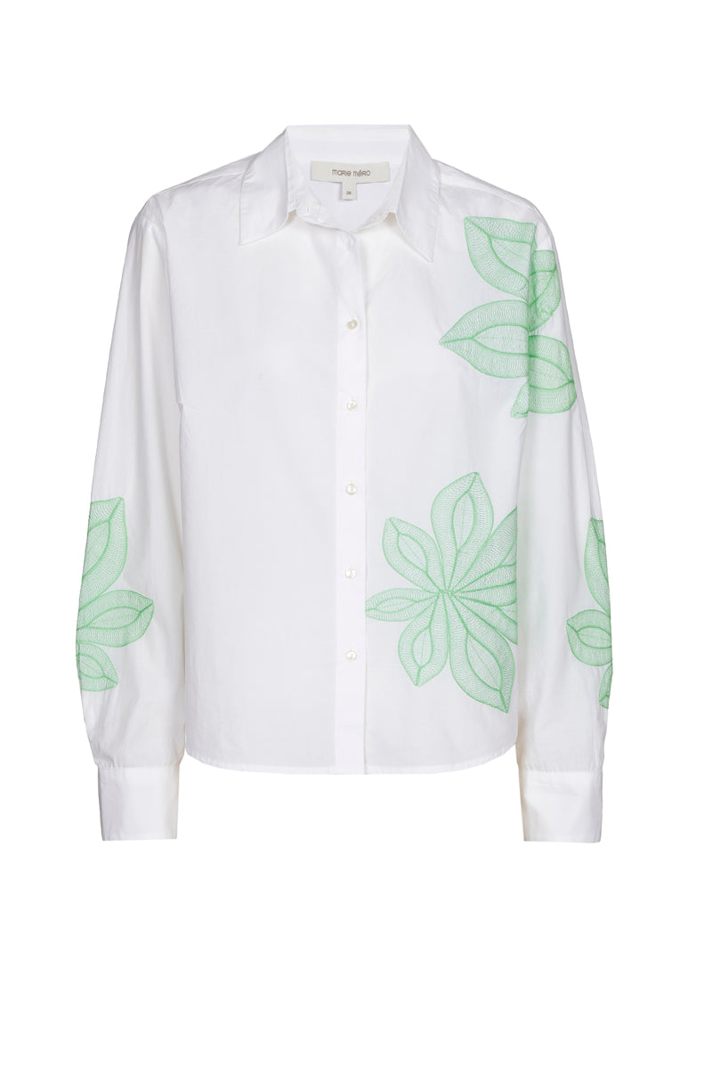 Chemisier blanc avec fleur verte
