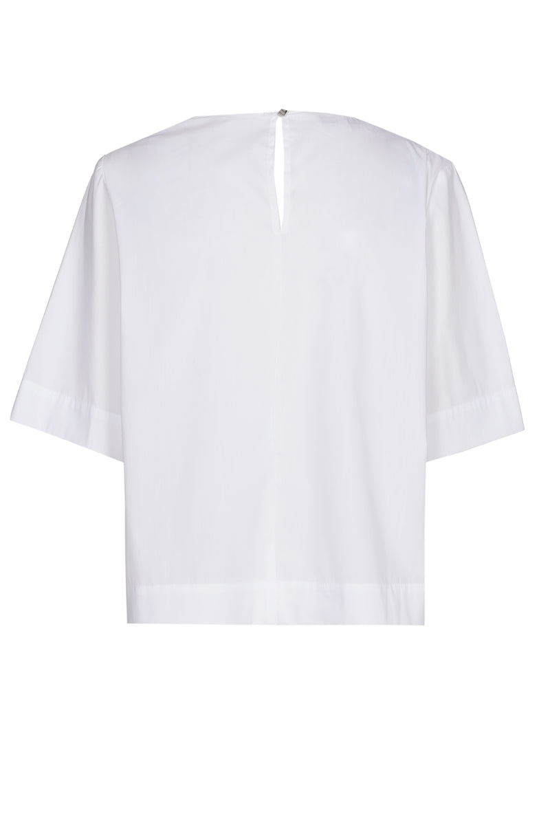 White shirt with brooch at the collar