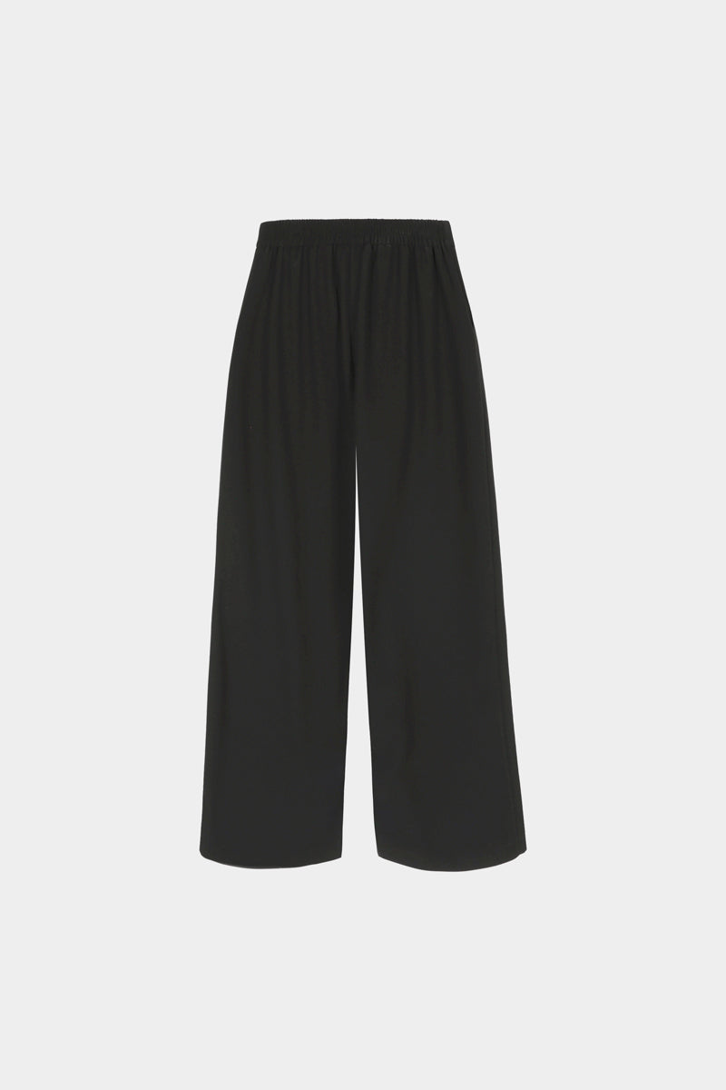 Wide black trousers with an elasticated back waistband