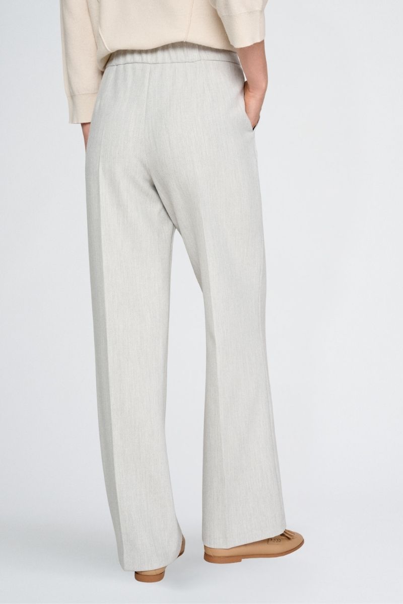Wide grey trousers and elastic at the back of the waist